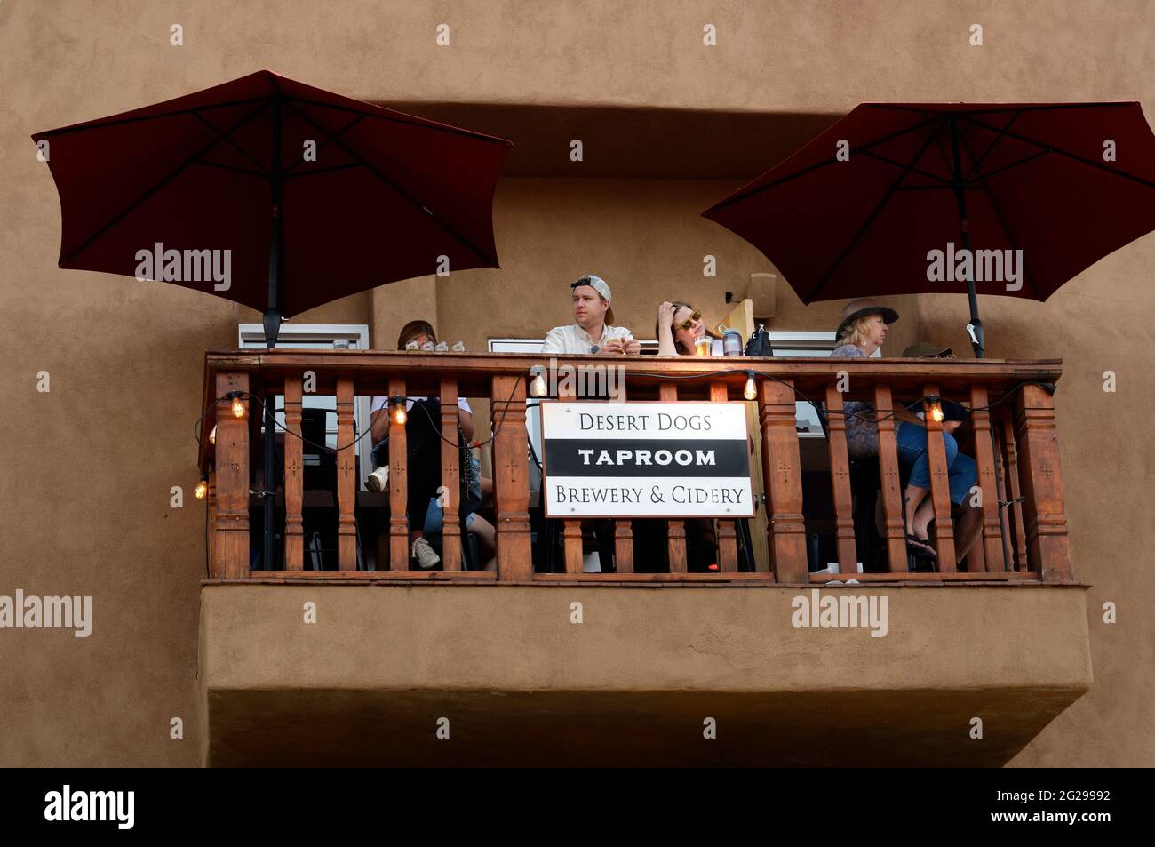 A couple enjoy their beers and the view from a second-story taproom patio in Santa Fe, New Mexico. Stock Photo