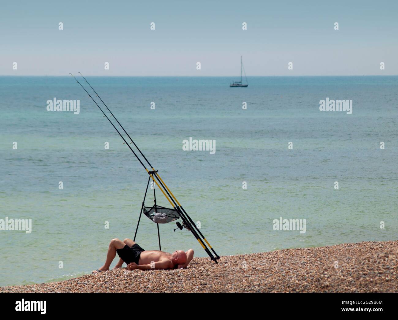 Fishing and sunbathing on the beach at Brighton Stock Photo