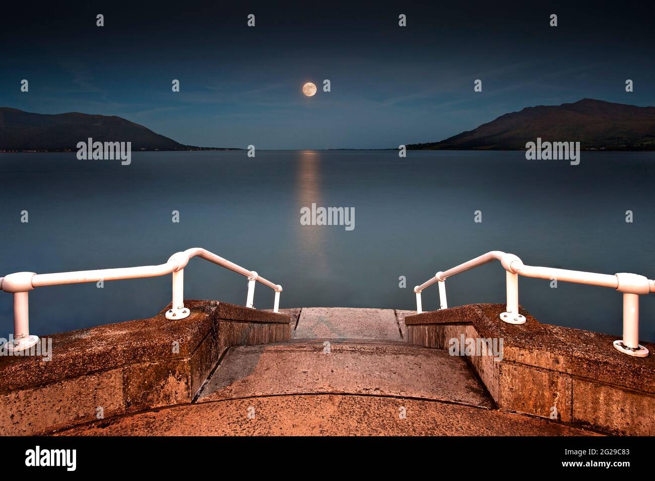 Moonrise over Carlingford Bay taken from the promenade at Warrenpoint. Warrenpoint is a small town  in County Down, Northern Ireland. Stock Photo
