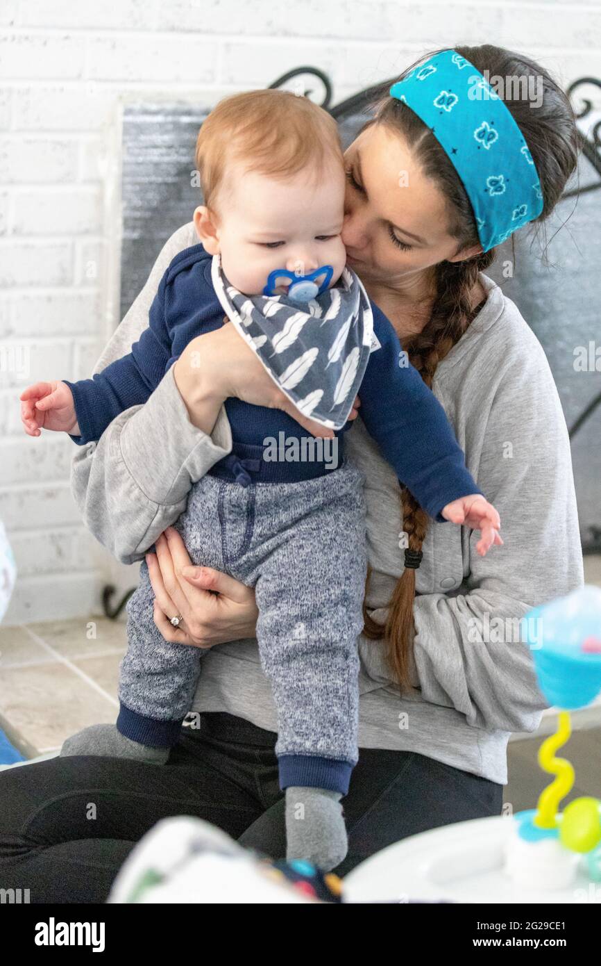 Loving mother kissing her baby boy. Stock Photo