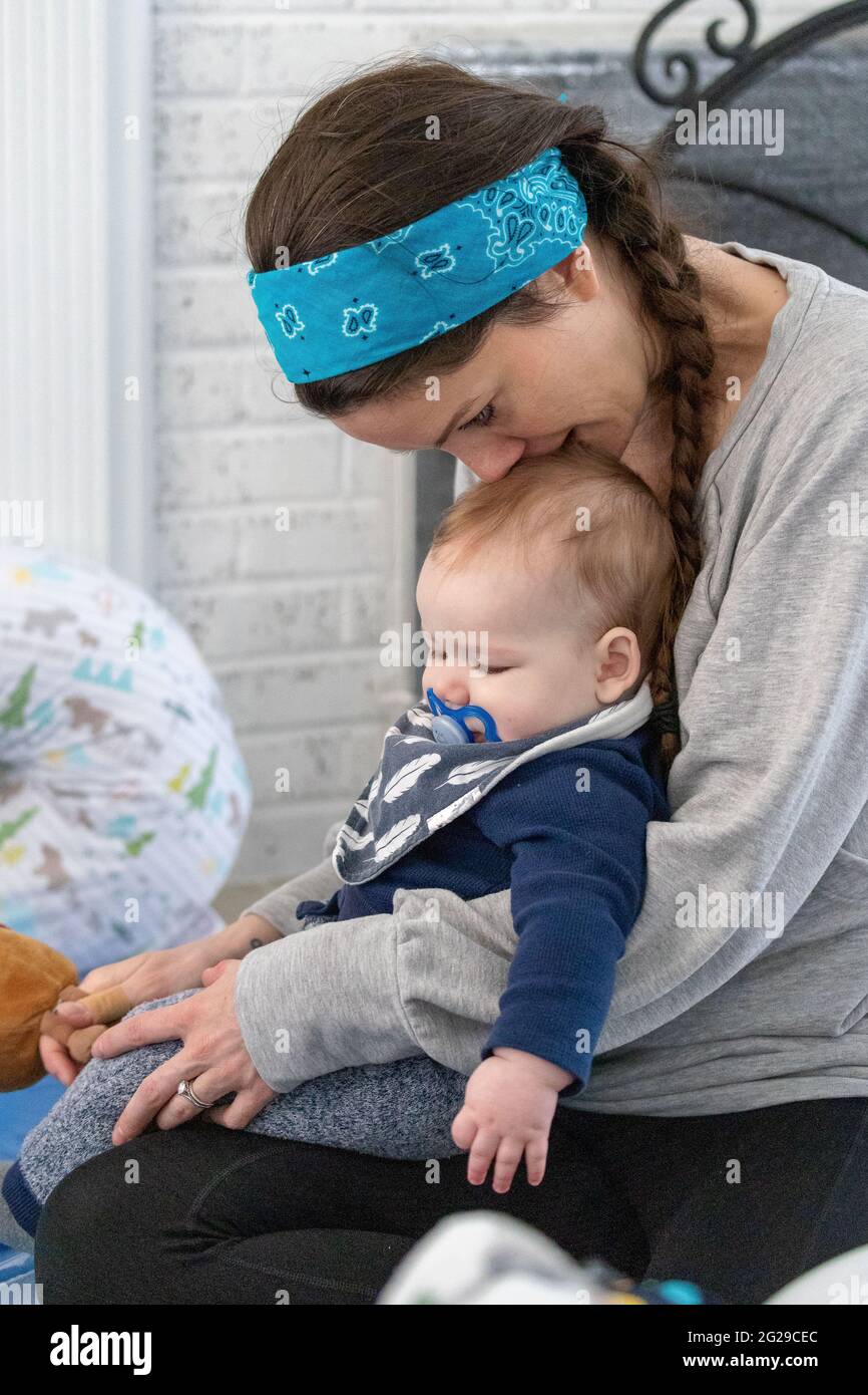 Mother holding her baby boy in love. Stock Photo