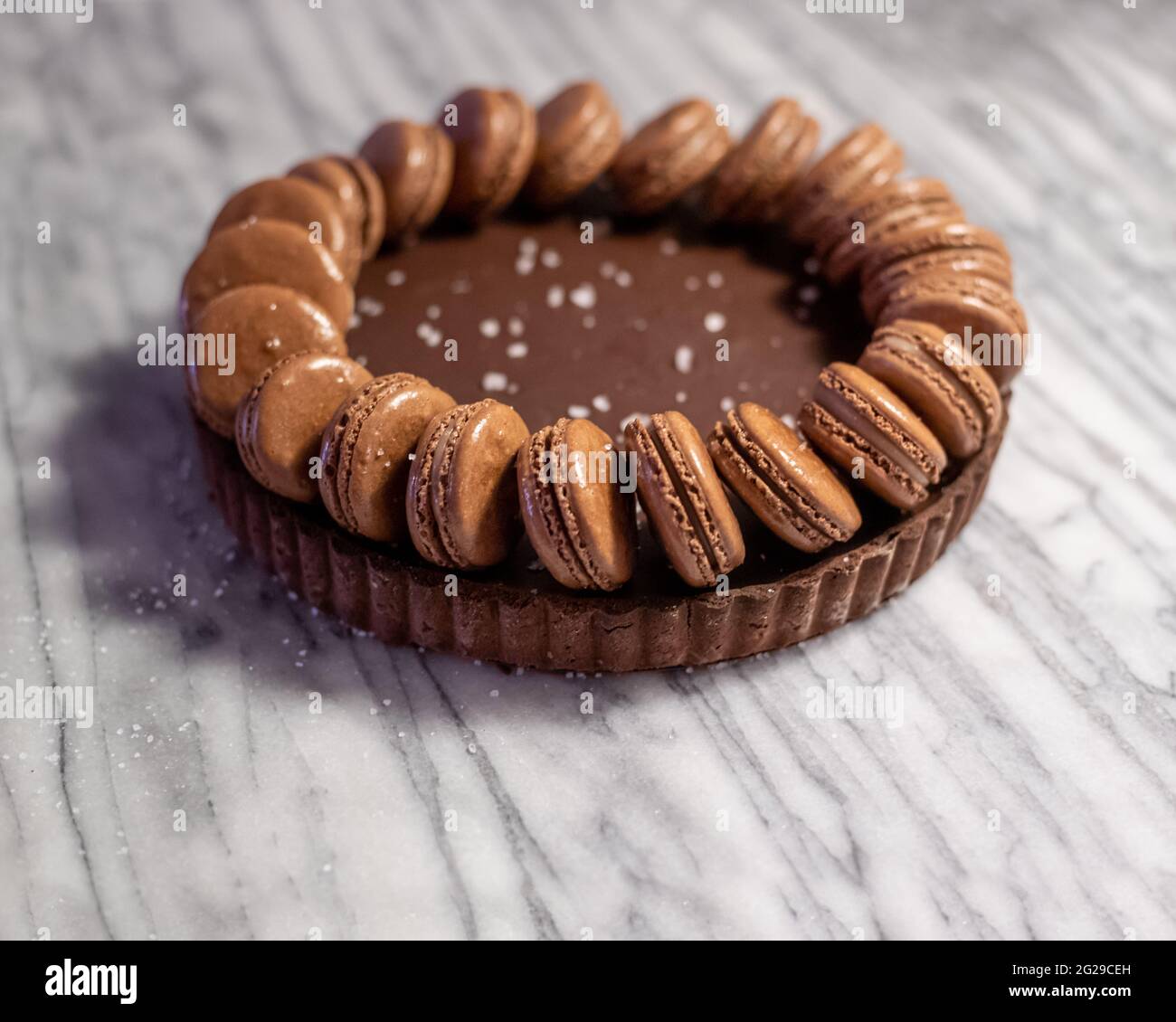Salted Caramel Dark Chocolate Ganache Tart with Macarons Stock Photo Alamy