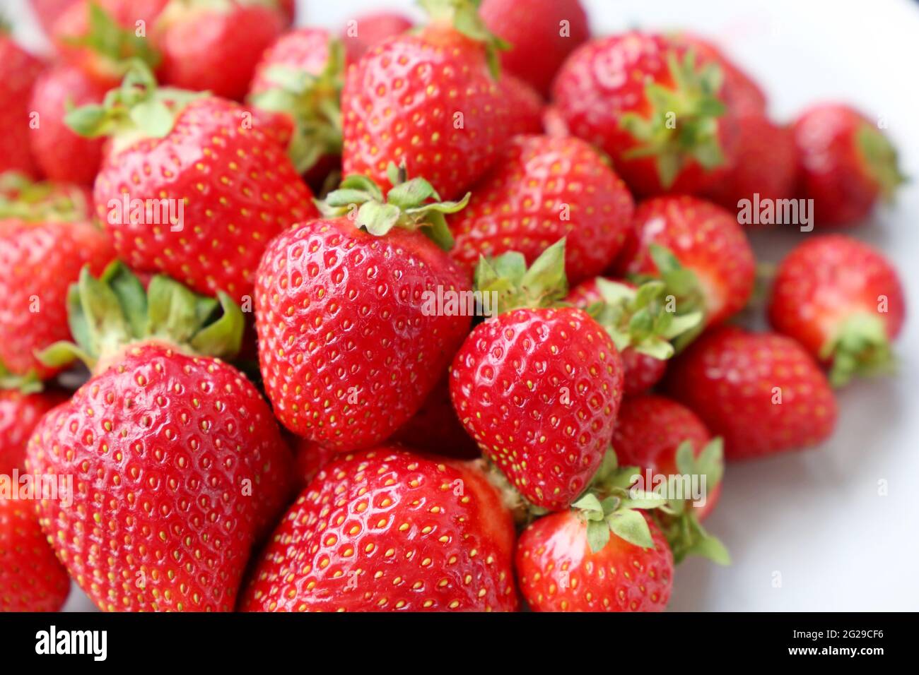 Fresh red strawberries with leaves. Pile of ripe strawberry for ...