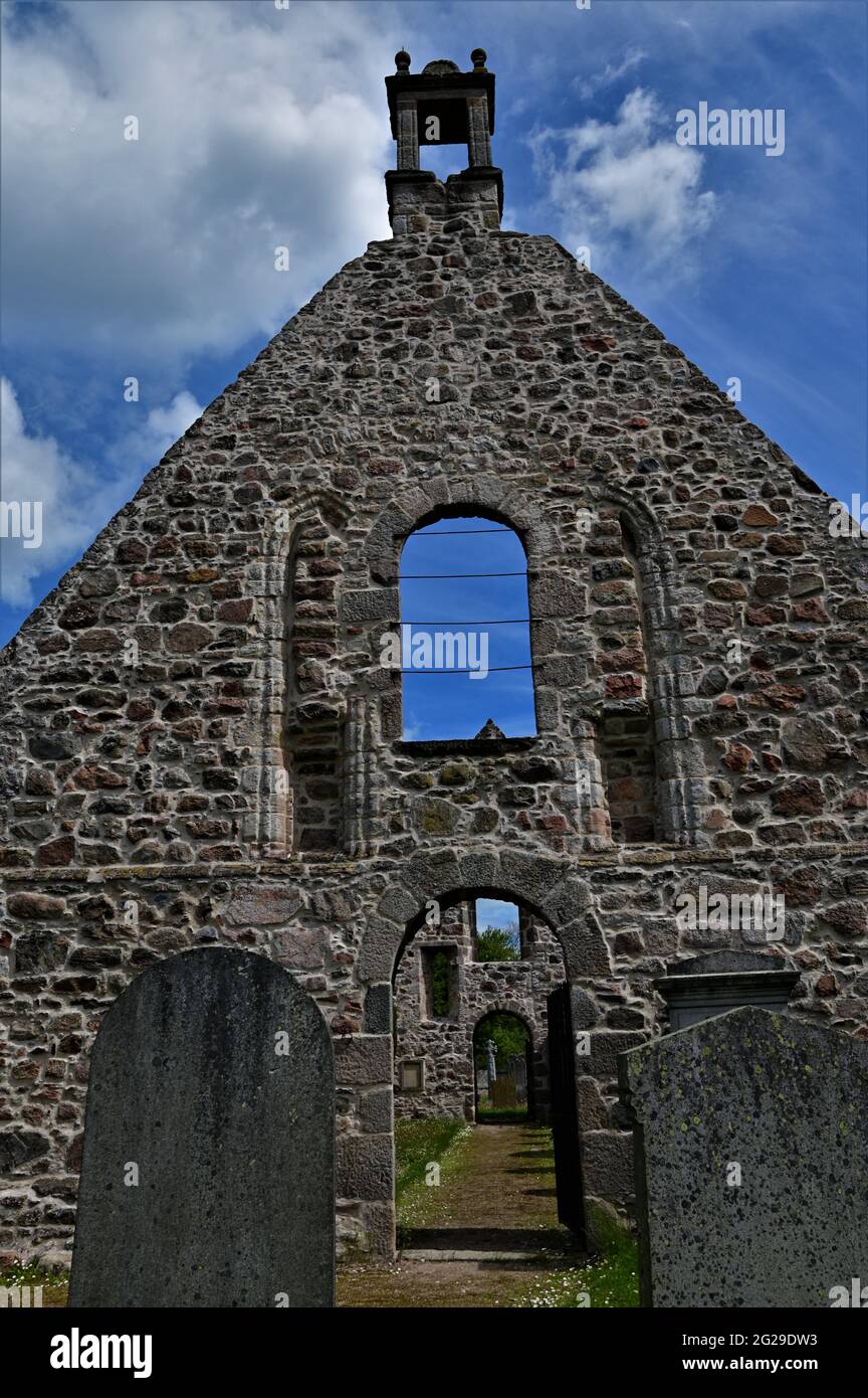 A view of the ruins of an old church building and graveyard in