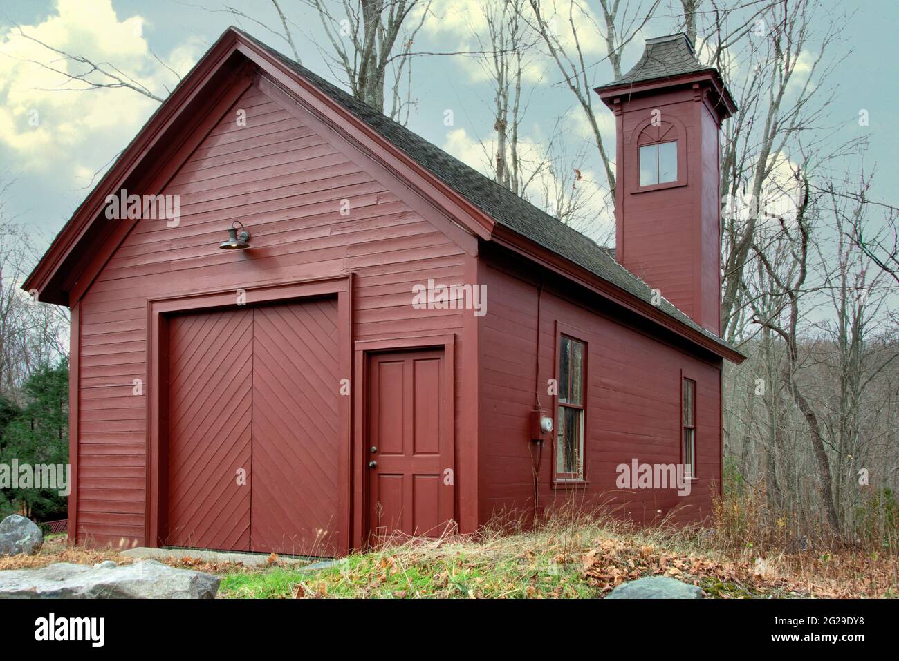 Old red fire station with tower used for drying hoses. Built in 1870, this  wood frame building is listed in the National Registry of Historic Places. Stock Photo