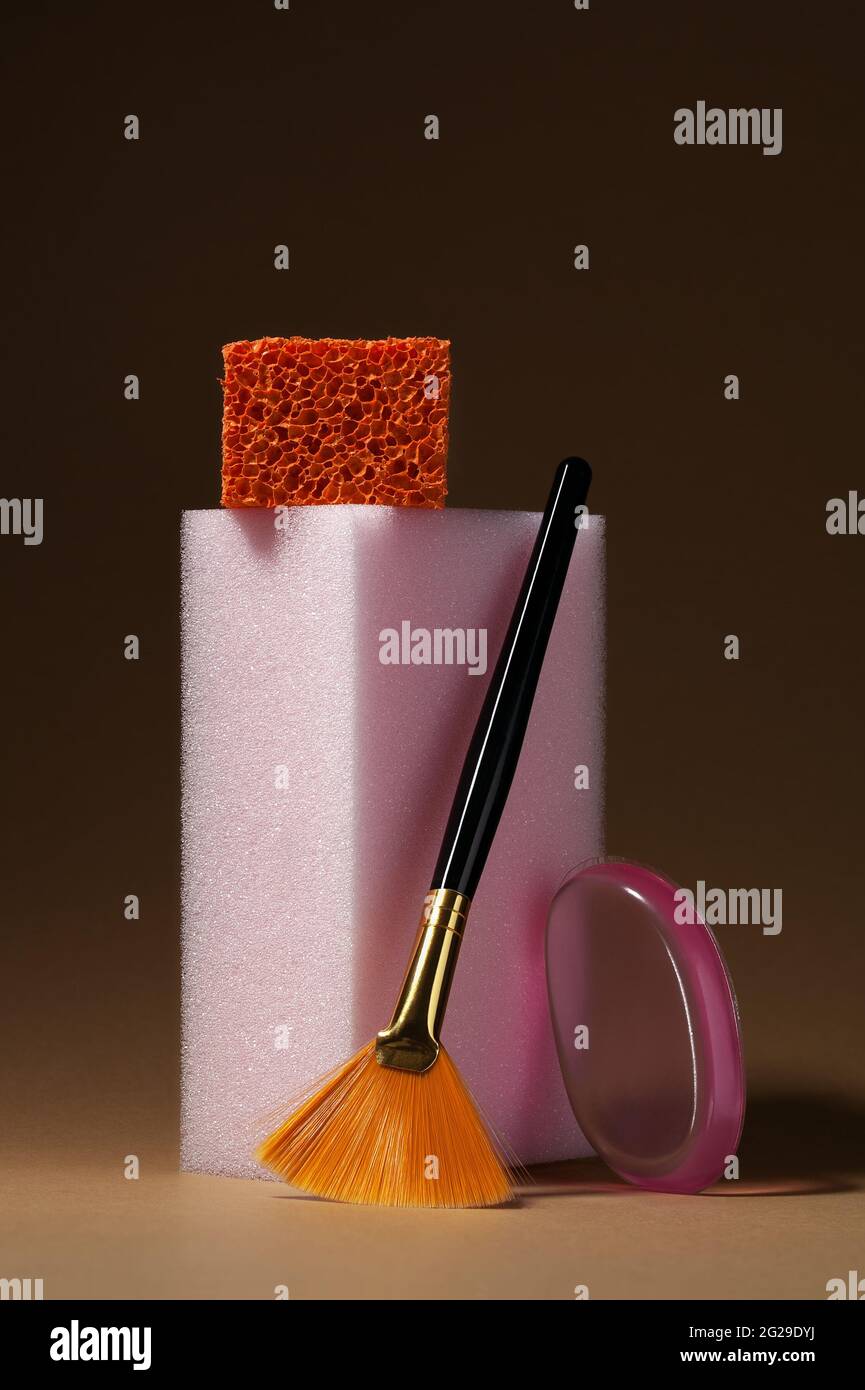 Make up cosmetic sponges and brush on beige background. Modern conceptual cosmetic still life Stock Photo