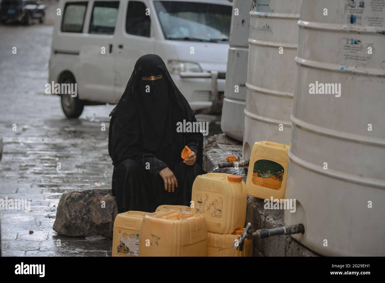Taiz Yemen 20 June 2020 A Yemeni woman fetches water due to the