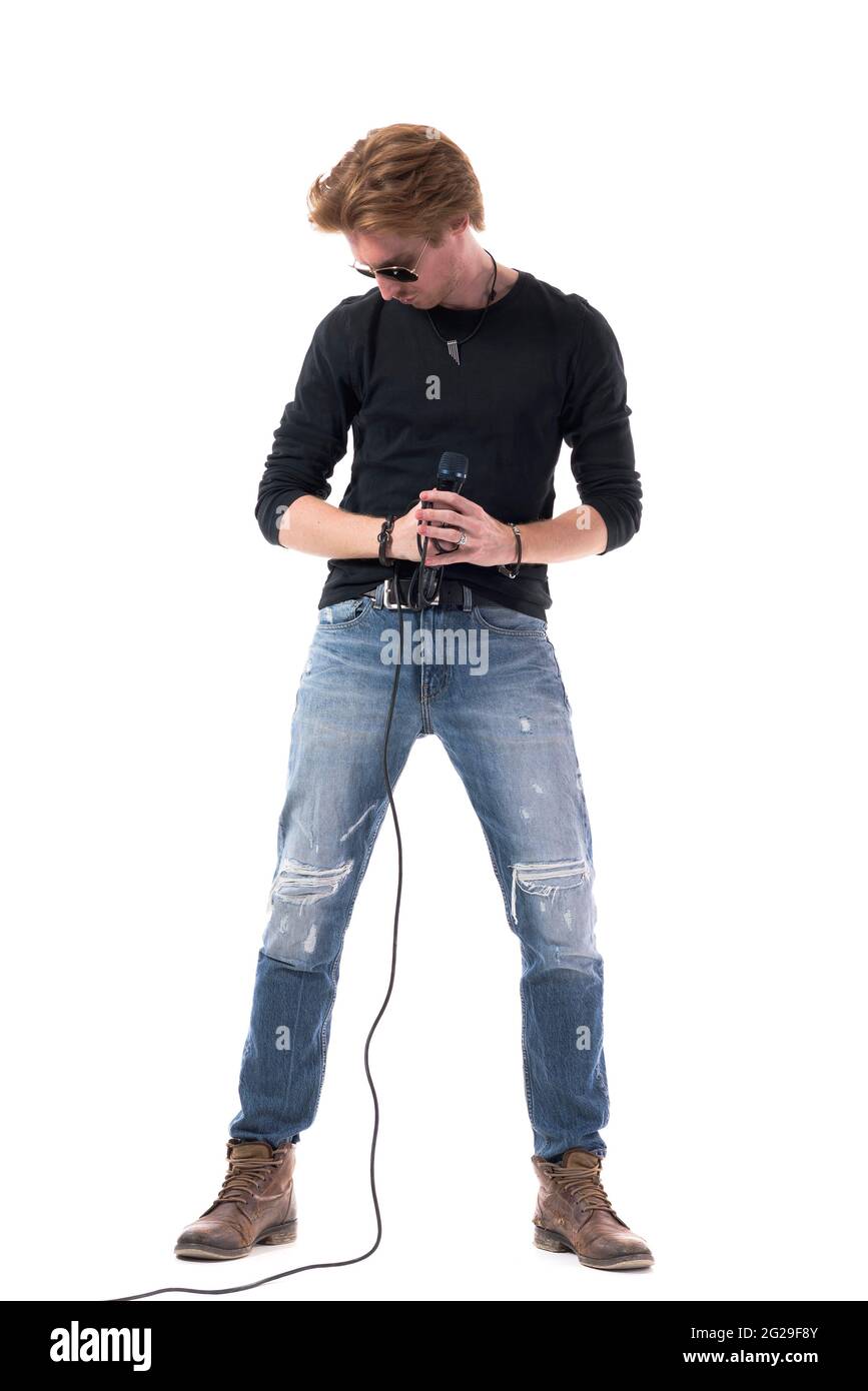 Rock music male singer taking pause looking down take breath. Full body length isolated on white background. Stock Photo