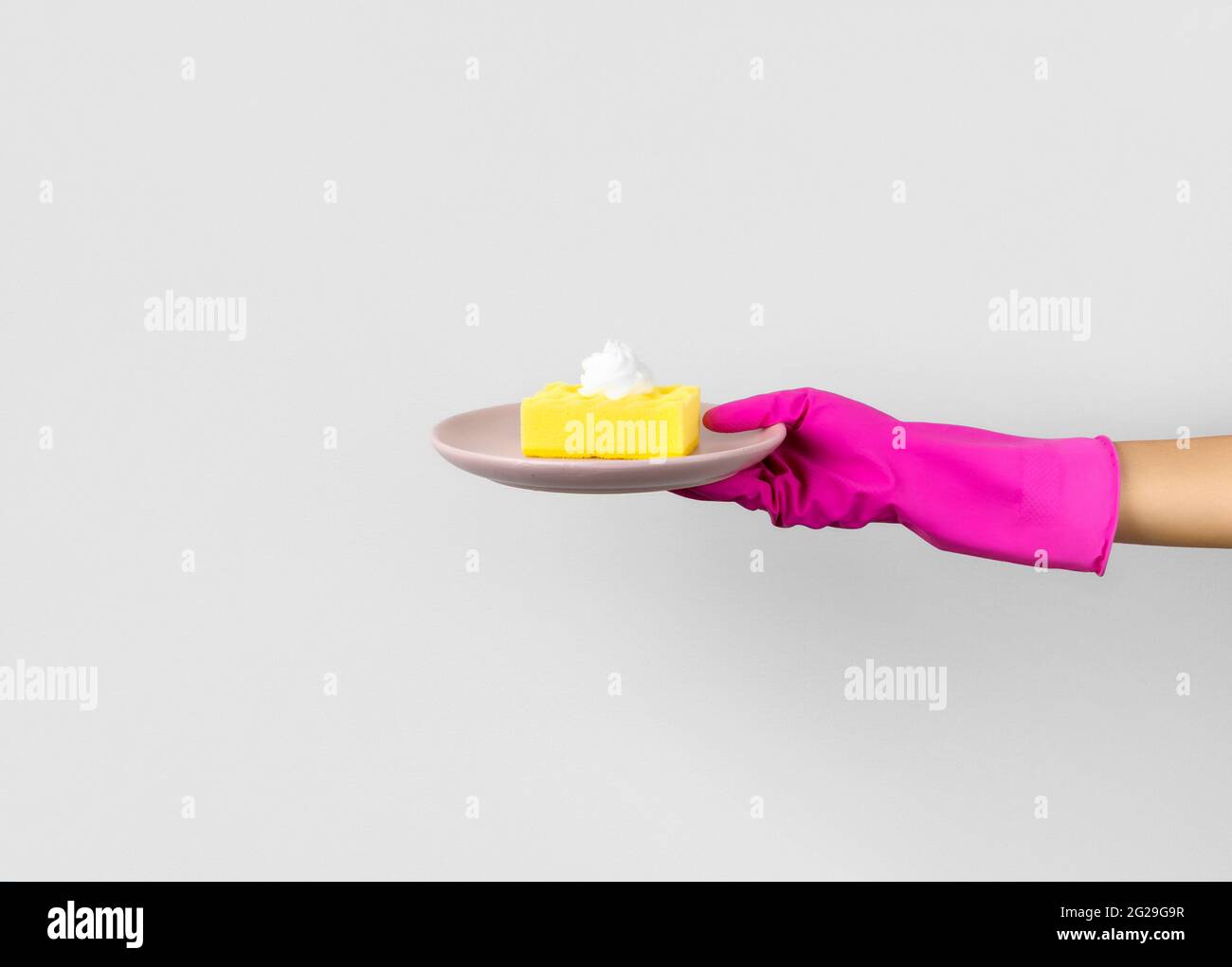 Womans hand in pink rubber glove holding sponge with foam Stock Photo ...