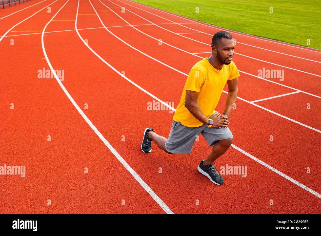 Portrait of sporty focused black man in sports wear warming up before  training outdoors, wearing yellow trendy sportswear.Young Afro American  Stock Photo - Alamy