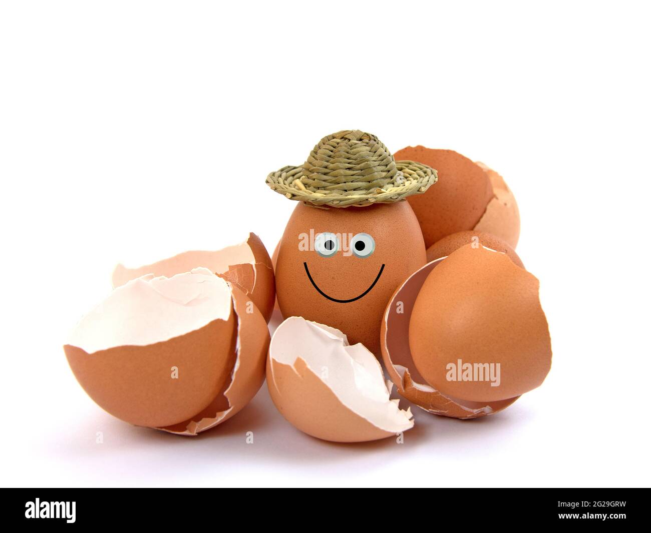 Egg with funny face and empty eggshells Stock Photo