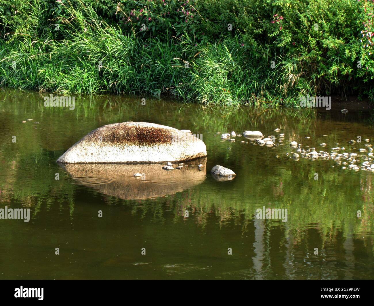 stones in the river, a rock protruding above the water surface, an idyllic natural shot Stock Photo