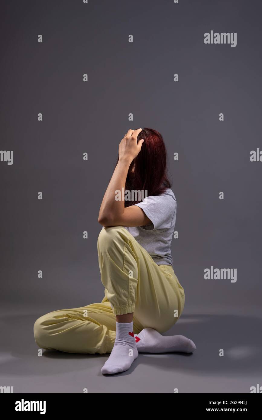 Hopeless girl sitting on floor hi-res stock photography and images - Alamy