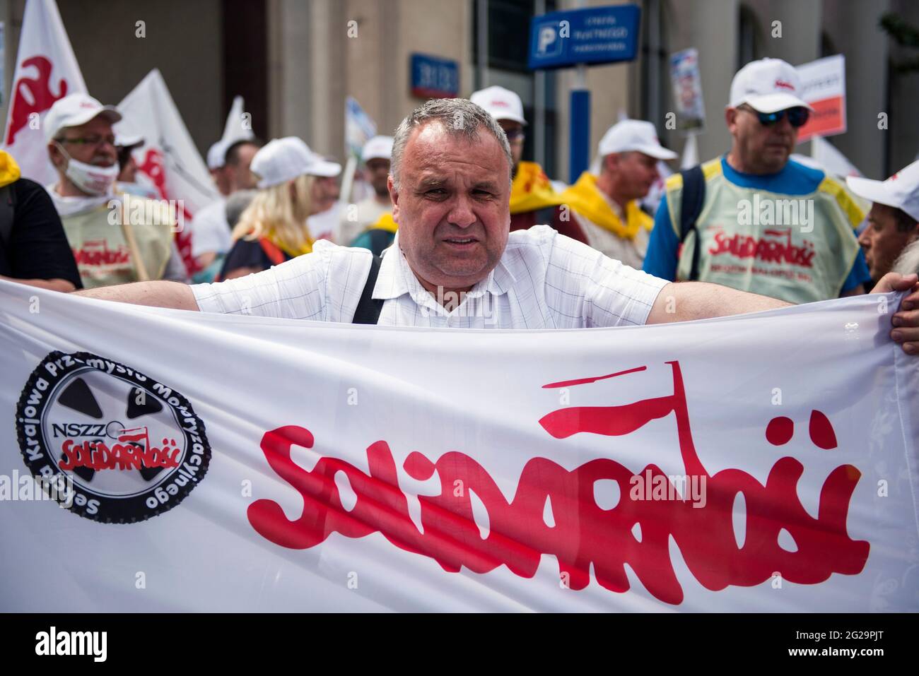 The legendary logo of Solidarnosc (Solidarity) is seen on a flag held by a miner during the demonstration.Thousands of Polish coal mining and energetics workers protested in Warsaw against the gradual phasing out of coal use and against a European Union court order to immediately close down the Turow brown coal mine - the ruling was in response to a lawsuit by the neighboring Czech Republic which says the mine is draining water from its border villages. The protest was organized by the Independent Self-Governing Trade Union 'Solidarnosc' (Solidarity). (Photo by Attila Husejnow/SOPA Images/Si Stock Photo