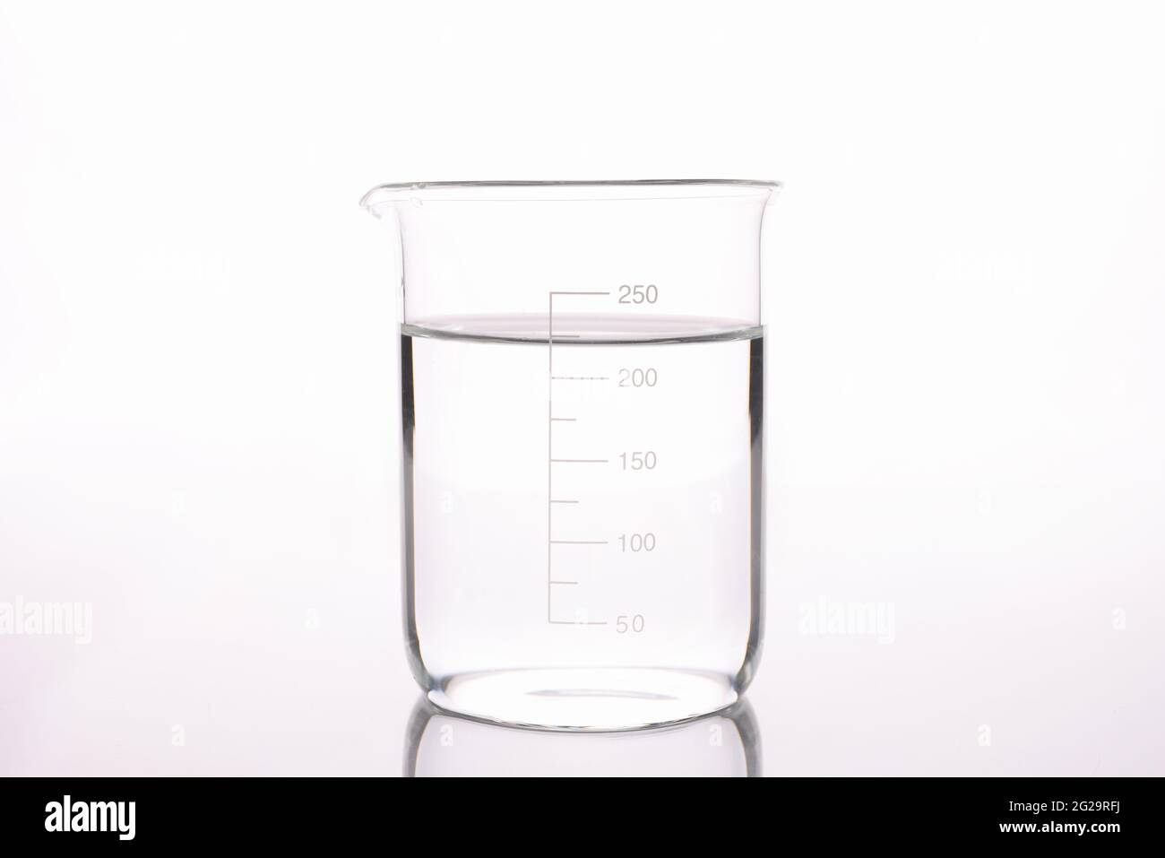 Sterilized water is poured into measuring glass closeup Stock Photo