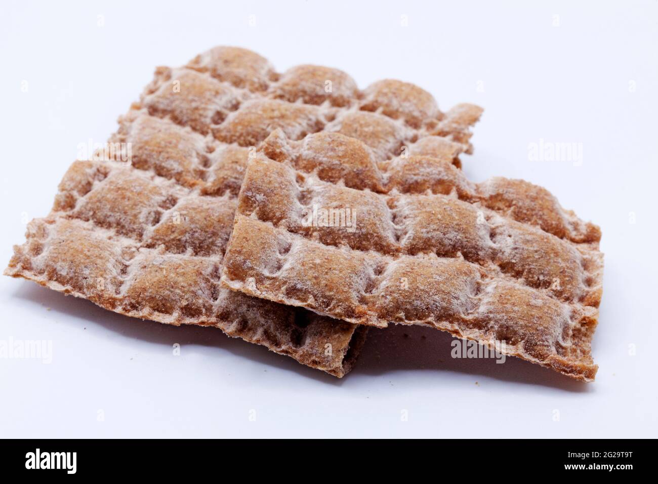 crumbled hard bread on white background Stock Photo