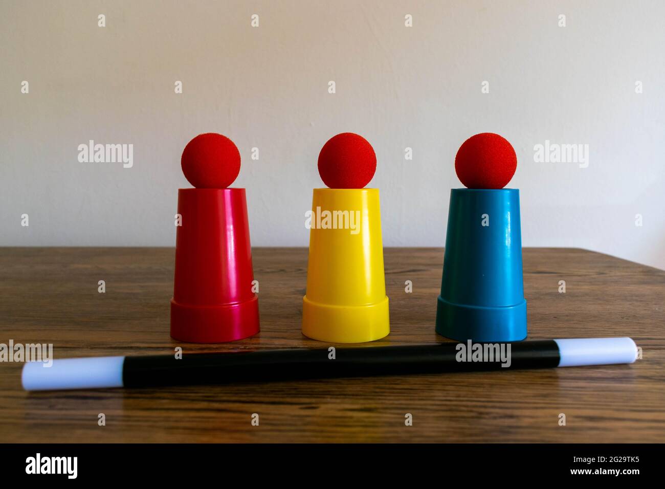 Magic show magicians trick concept background. Children's magic box with sequined top hats, magic wand, playing cards, cup and ball trick, secret draw Stock Photo