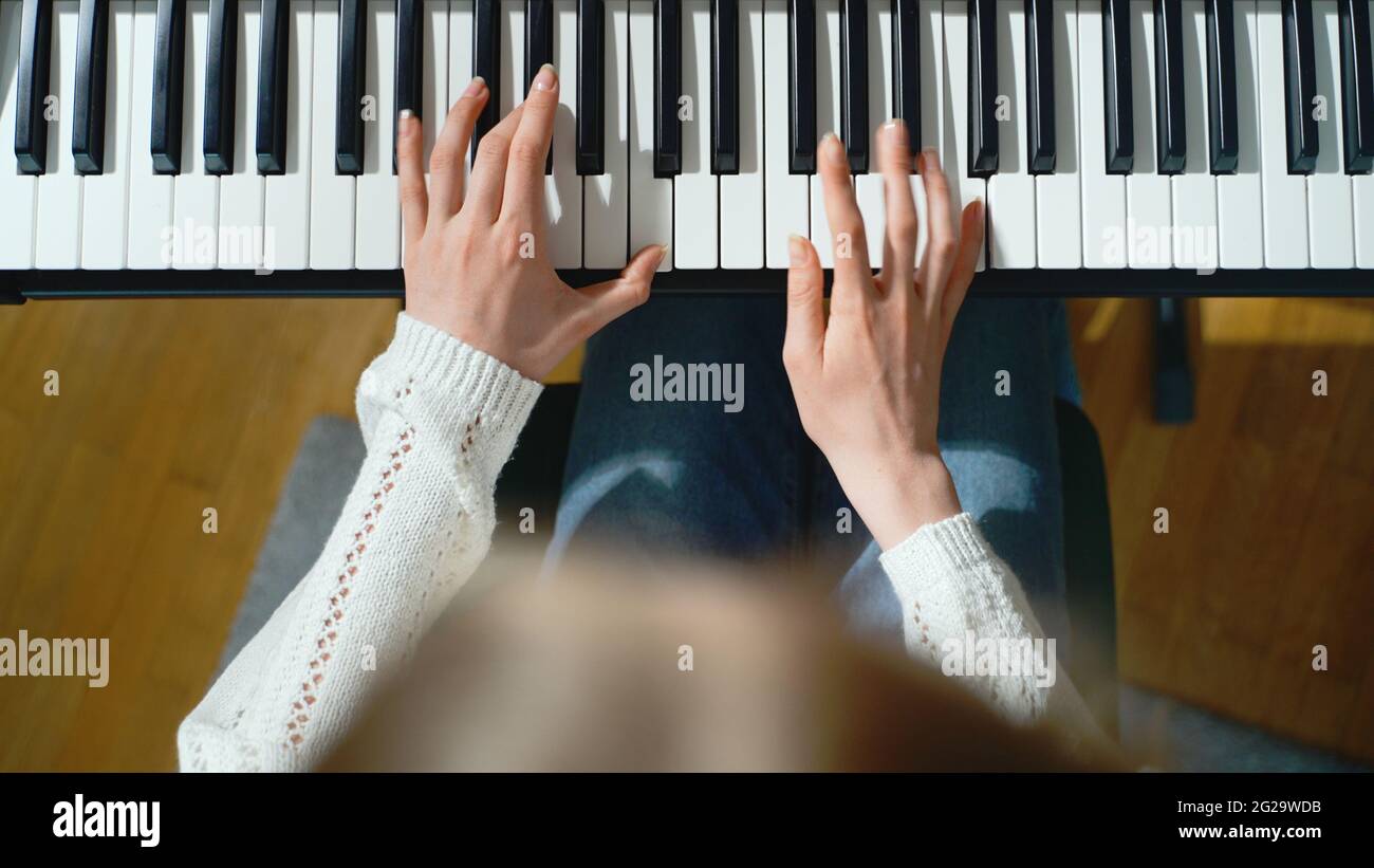 Girl playing the piano. Top view Stock Photo - Alamy