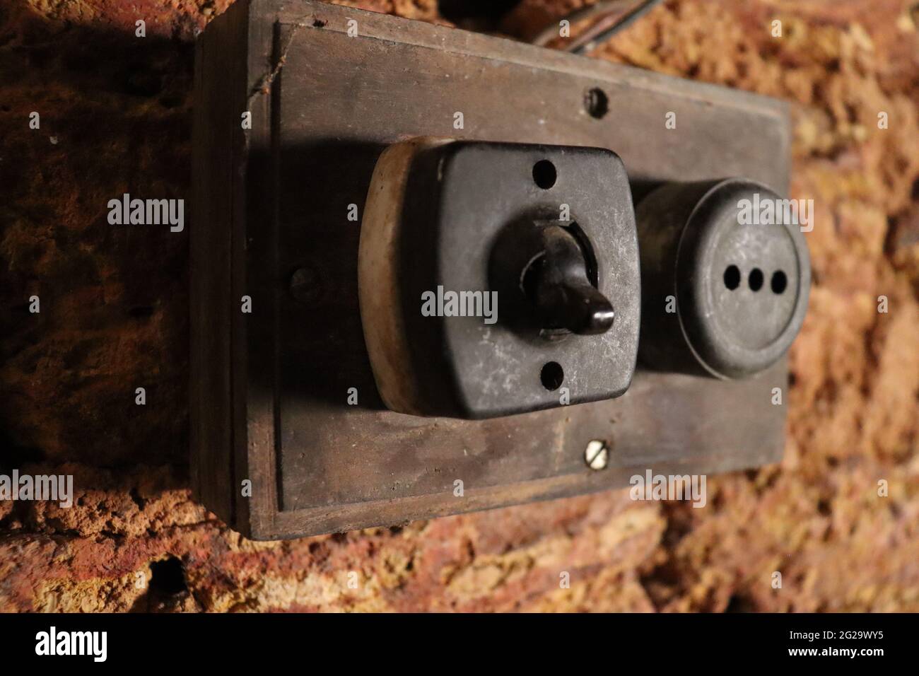Old Vintage Light Switch And Electric Plug Socket. Antique style flush panel mounting switch