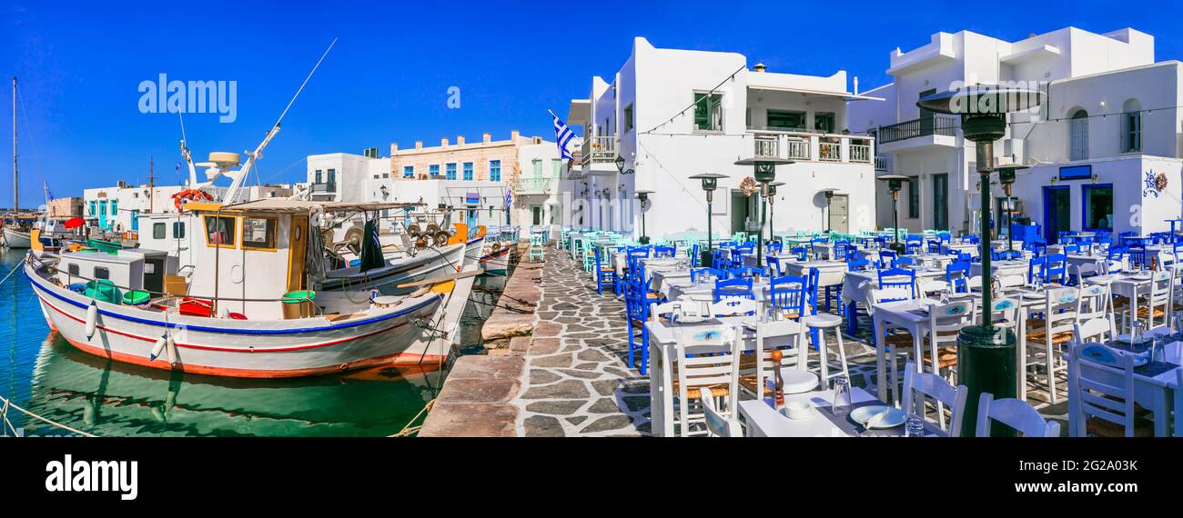 Greece travel. Cyclades, Paros island. Charming fishing village Naousa. view of port with street bars and restaurants (taverns) by the sea. Stock Photo