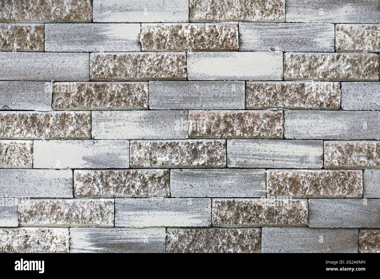 Pastel brick wall. Grey and light brown masonry pattern. Cement block painted texture, grunge architectural element. Abstract backdrop. Building's Stock Photo
