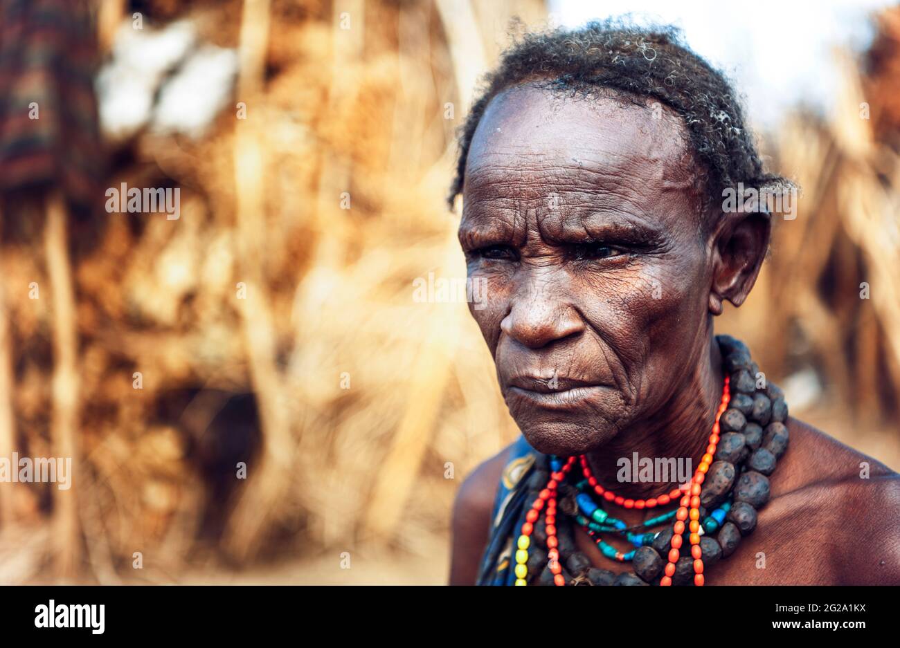Serious senior Woman from Dassanech tribe in a village, Omo valley, Ethiopia Stock Photo