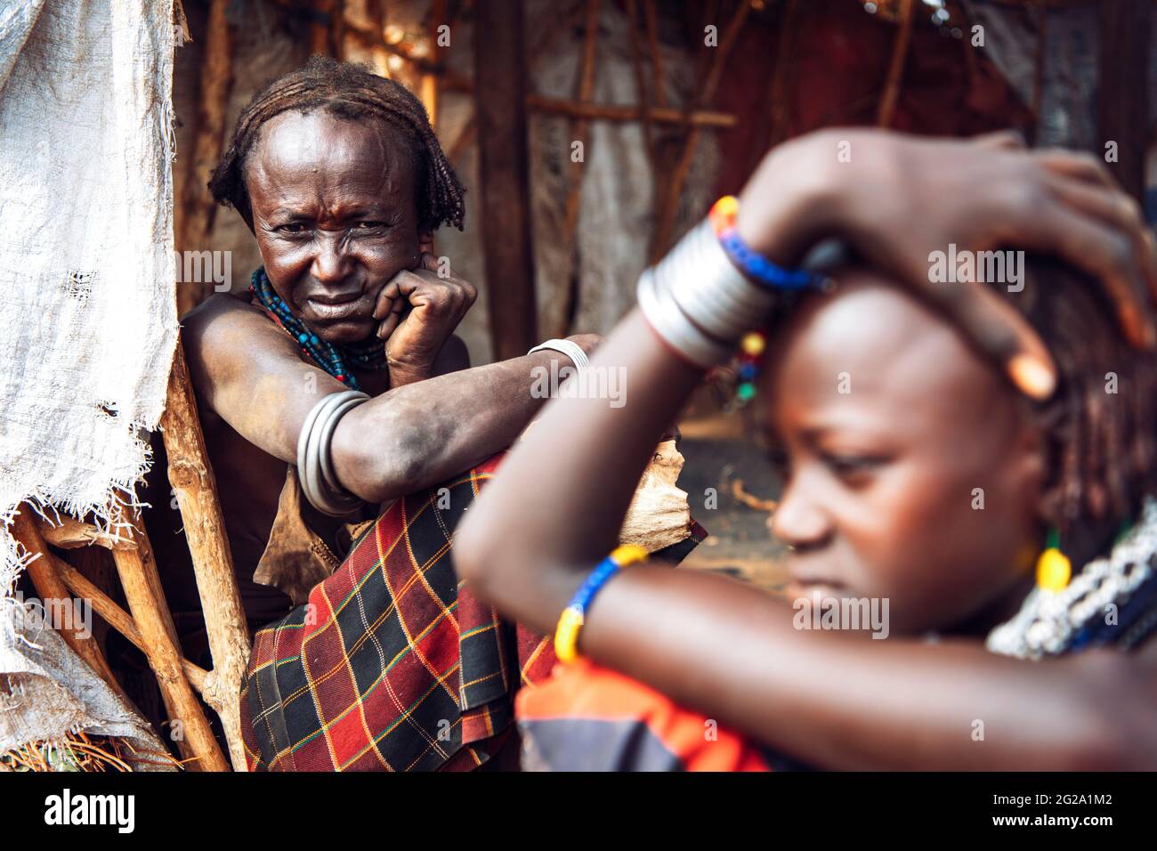 Young and old women from Dassanech tribe in village, Omo valley, Ethiopia Stock Photo