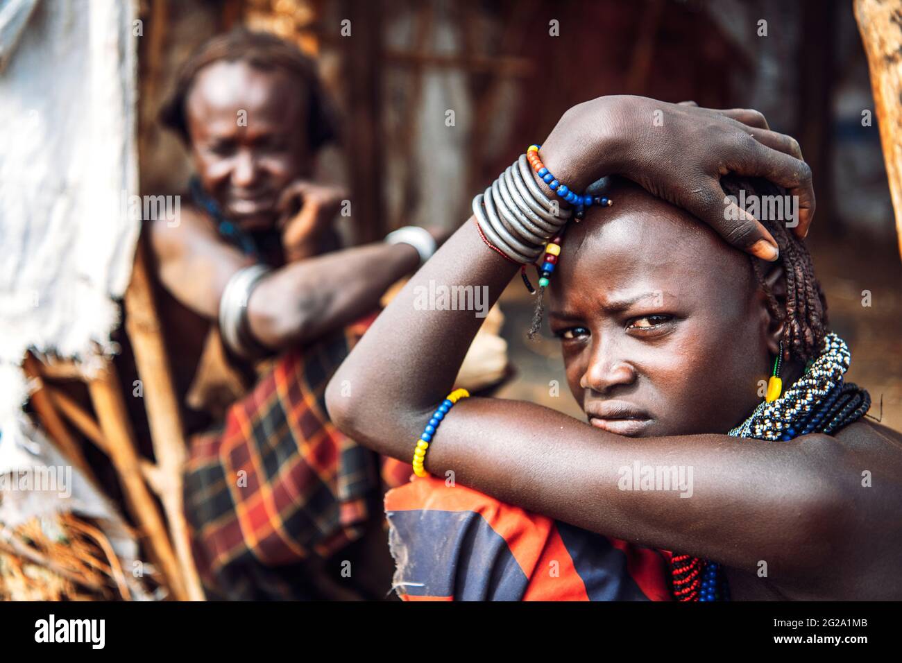 Young and old women from Dassanech tribe in village, Omo valley, Ethiopia Stock Photo