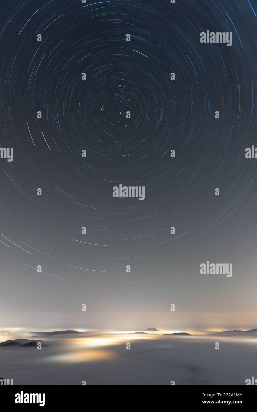 Long expose of rainy sky above cloud sheet with flecks of light Stock Photo