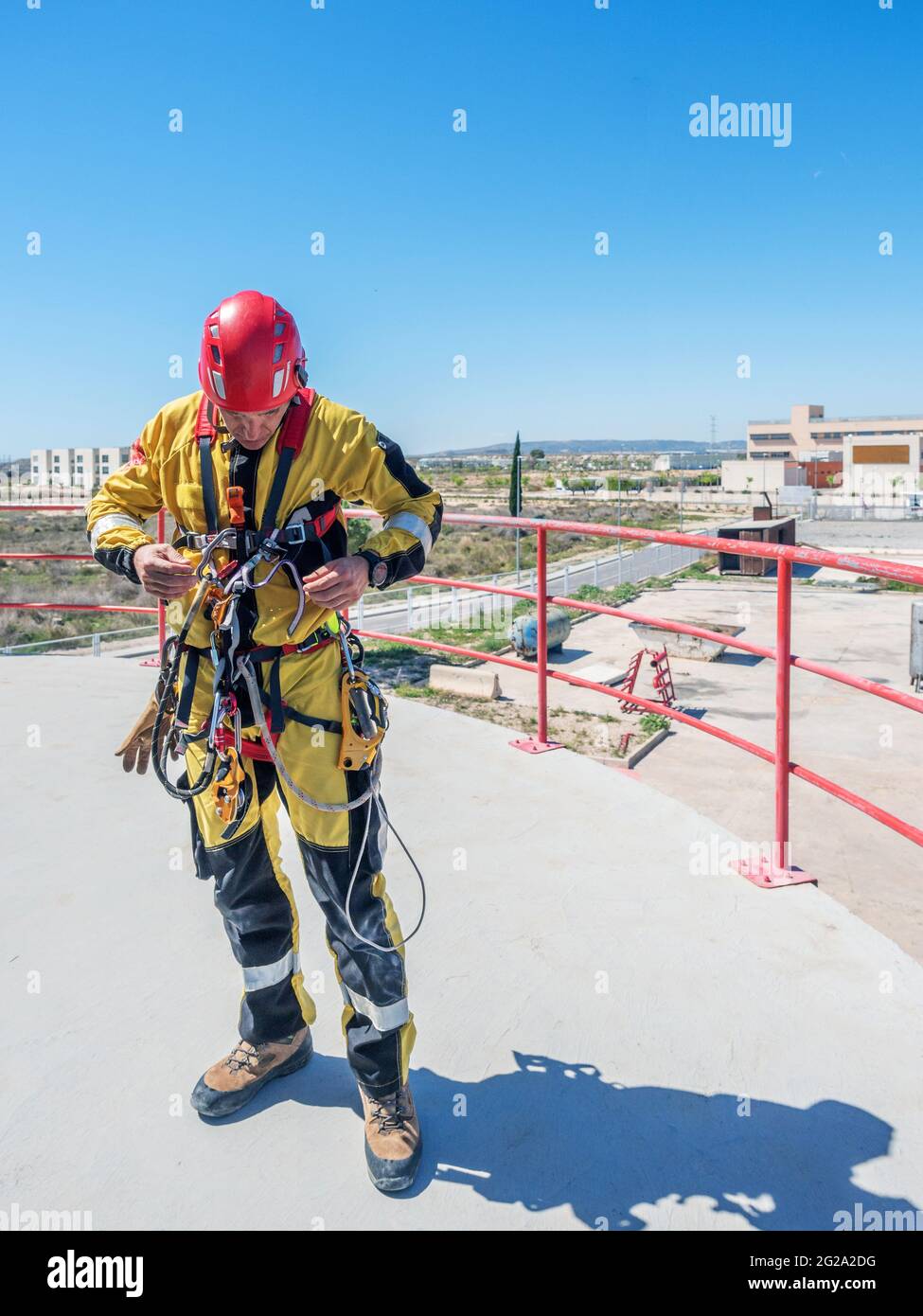 Professional fireman climber in uniform getting ready for climbing
