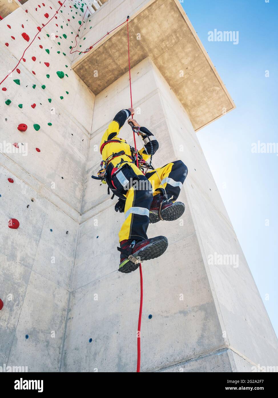 Anonymous man climbing rope hi-res stock photography and images - Alamy