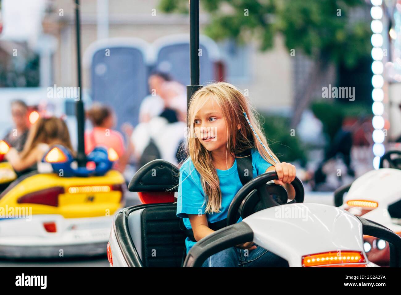 Little girl in cars bumper in fair Stock Photo - Alamy