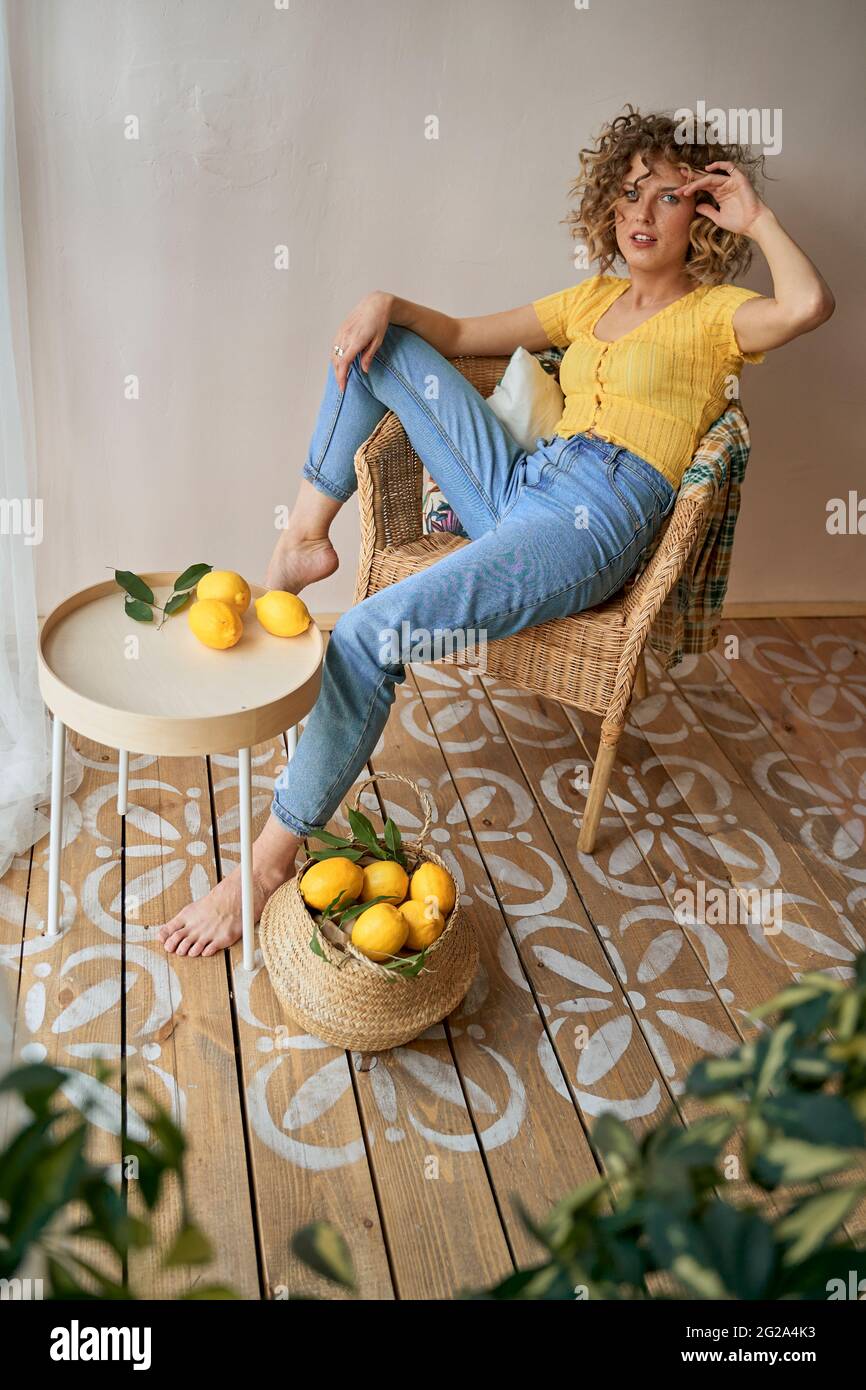 Woman sitting in armchair barefoot hi-res stock photography and images ...