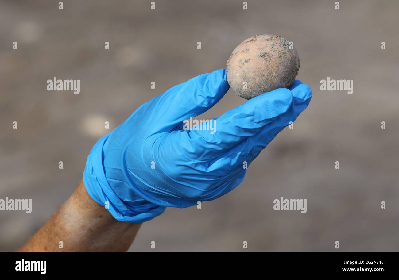 Yavne, Israel. 9th June, 2021. An Israeli archeologist shows an intact chicken's egg of roughly 1,000 years ago in Yavne, central Israel, on June 9, 2021. Israeli archeologists have discovered an intact chicken's egg of roughly 1,000 years ago, the Israel Antiquities Authority (IAA) said Wednesday. The egg was found in an excavation site in Yavne, in a cesspit dating from the Islamic period. Credit: Gil Cohen Magen/Xinhua/Alamy Live News Stock Photo