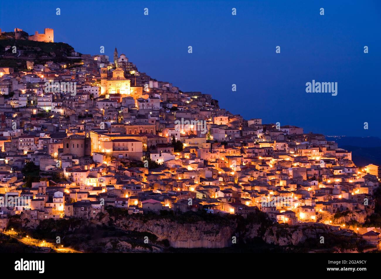 view by night of dwellings and the church of Santa Margherita in the city of Agira in Sicily Stock Photo