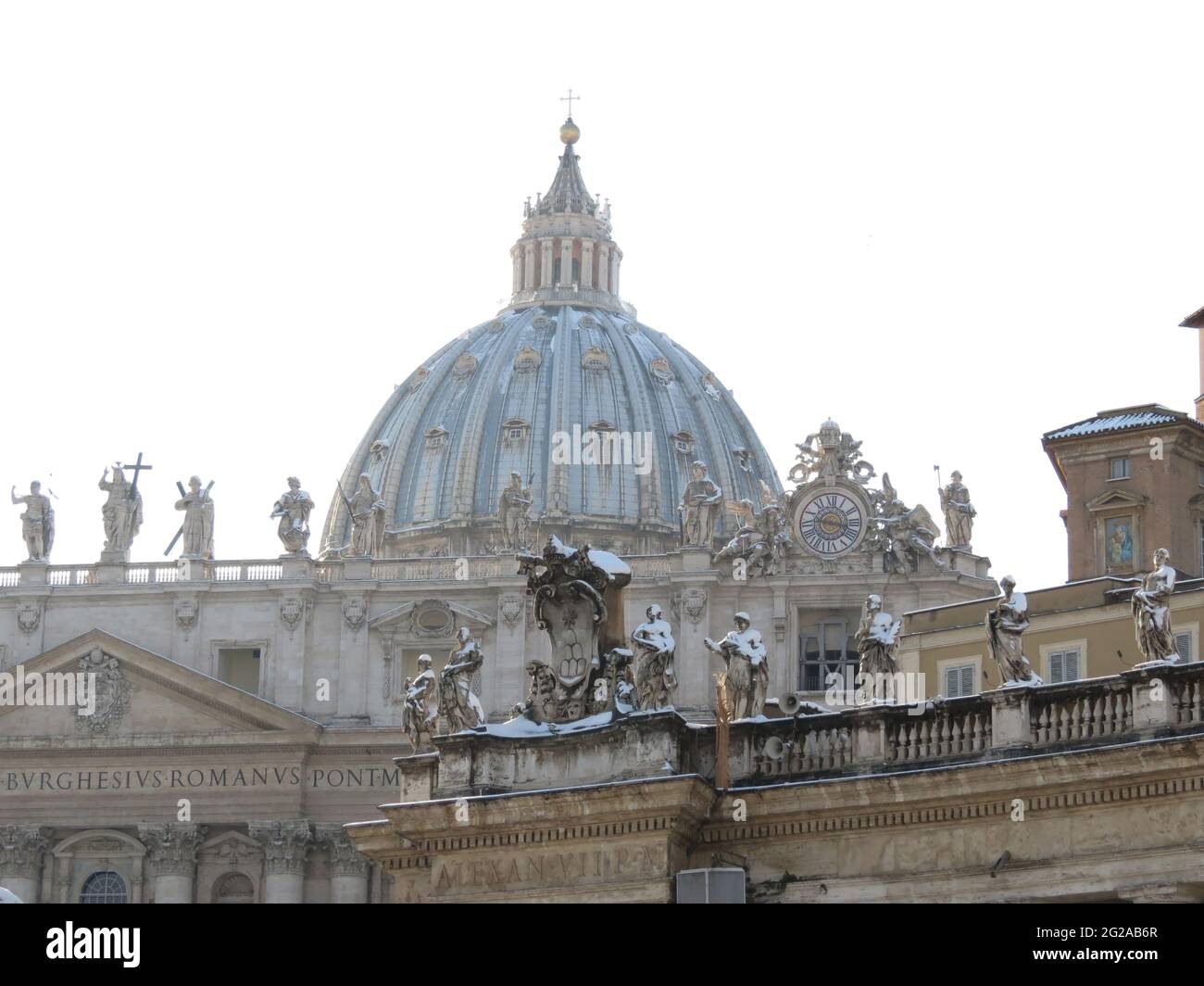 Dome and statues covered with snow in Saint Peter's Place, Rome, Italy Stock Photo