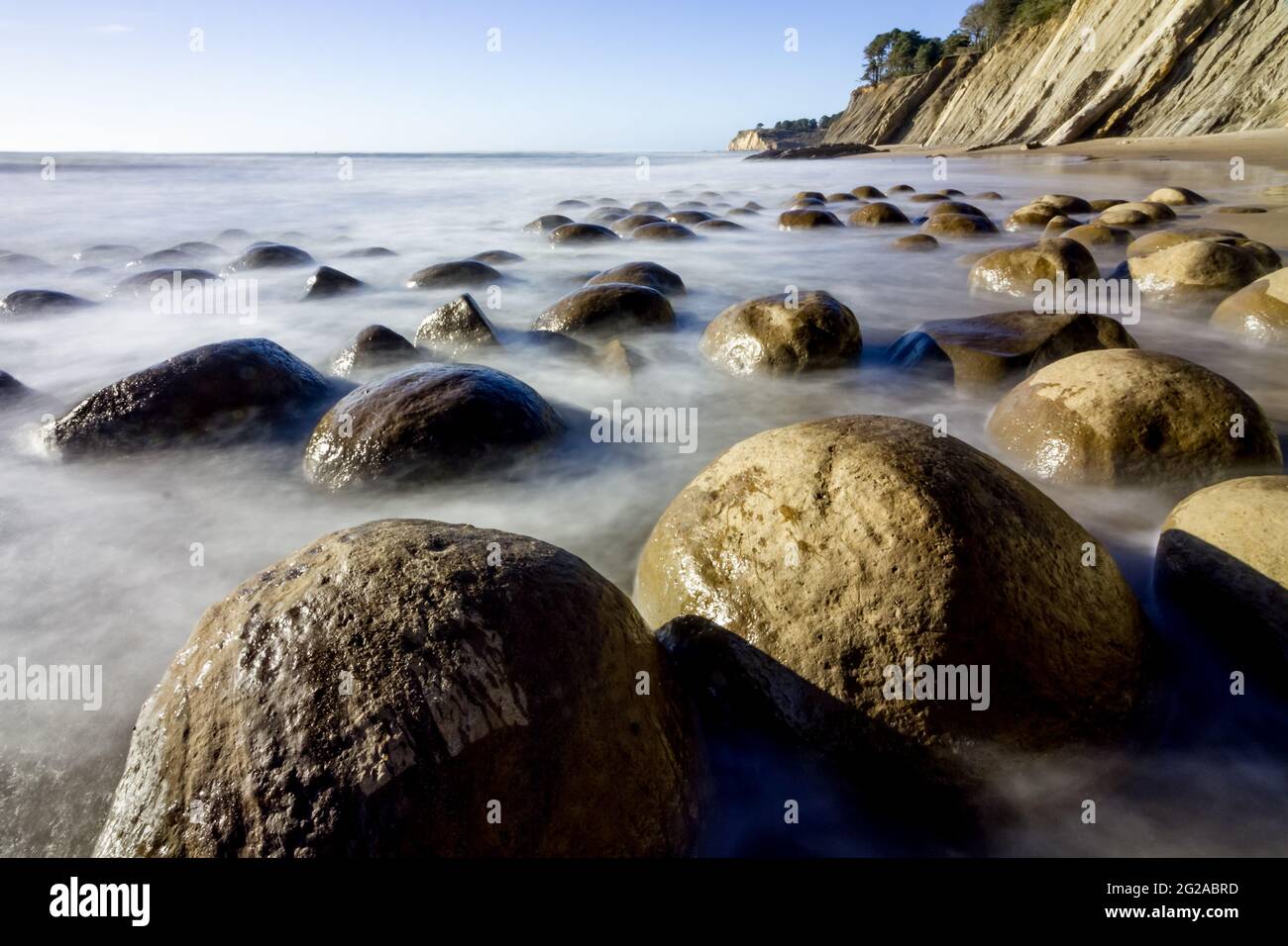 Smoke on the Water - Wave-smoothed boulders appear to emerge from a smoky Pacific in this long exposure. Bowling Ball Beach, Point Arena, CA, USA Stock Photo