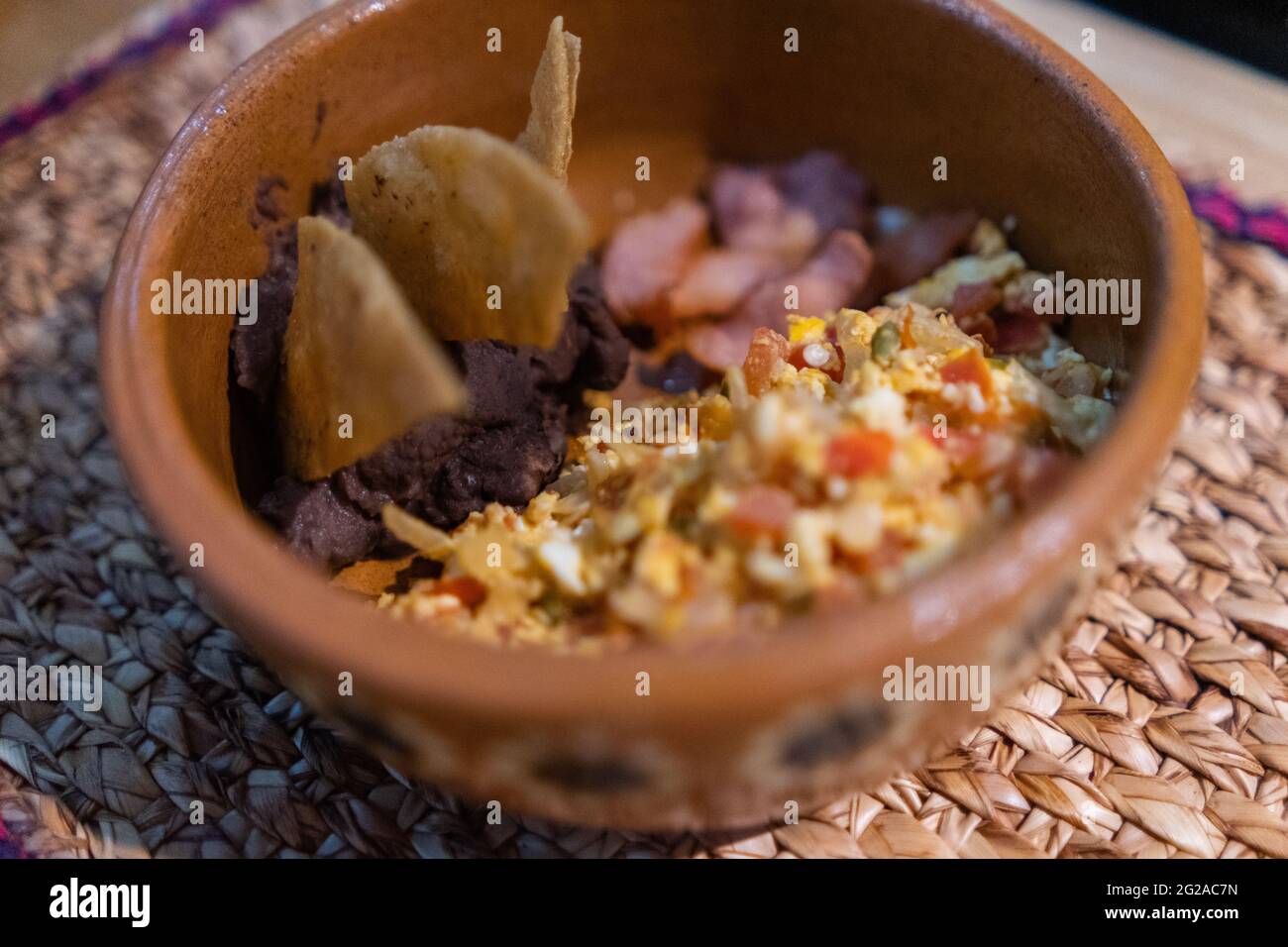 Mexicanstyle eggs, bacon, and refried beans with tortilla chips in