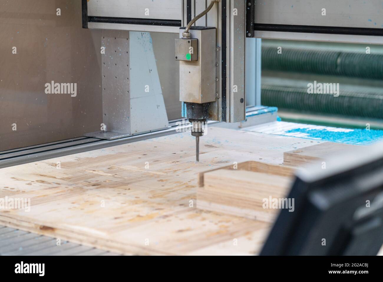 Cnc machine at work process cutting wood with drill, close up. Stock Photo