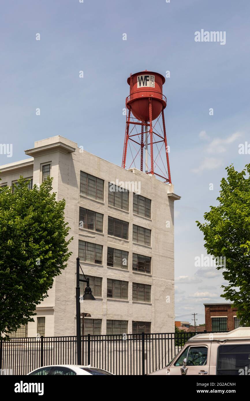WINSTON-SALEM, NC, USA-1 JUNE 2021: Water tower atop the Winston Factory Lofts. Vertical image. Stock Photo