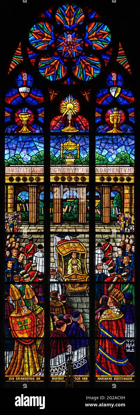 Stained-glass window depicting the Eucharistic Congress in Vienna in 1912. Votivkirche – Votive Church, Vienna, Austria. Stock Photo
