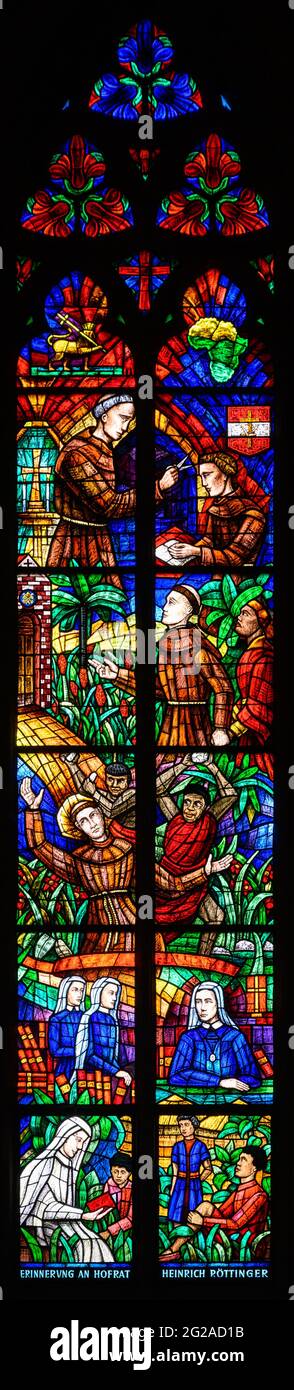 Stained-glass window depicting missionaries in Africa, namely the Franciscan Liberatus Weiß and Countess Maria Theresia Ledóchowska. Votivkirche. Stock Photo