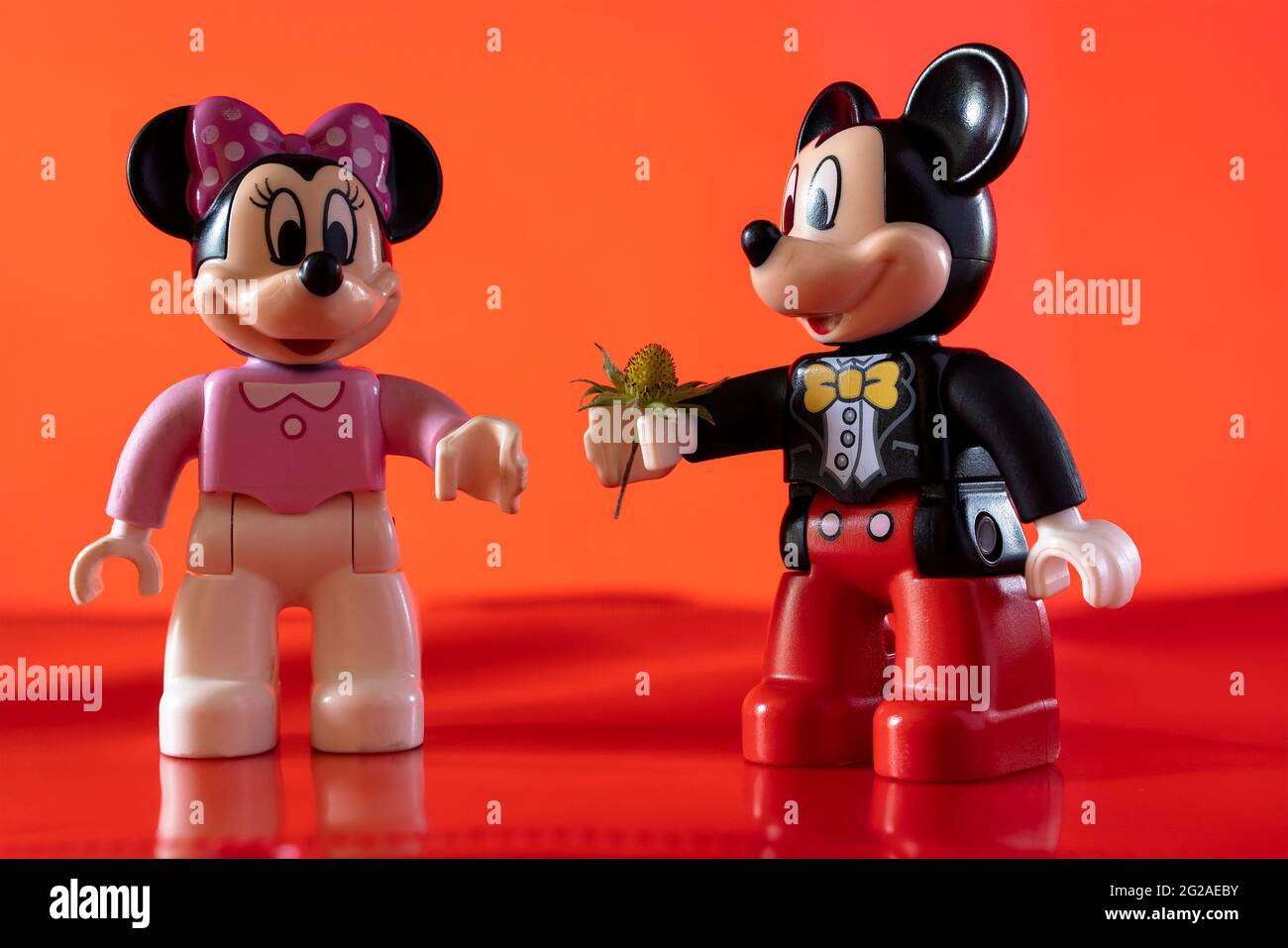 New York, USA - May 25, 2021: A close up shot of a miniature famous Disney character Mickey Mouse Disney character handing over a flower to Minnie Mou Stock Photo