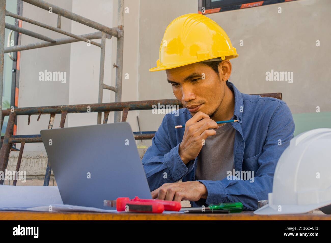 Worker employee working by computer technology on site construction ...