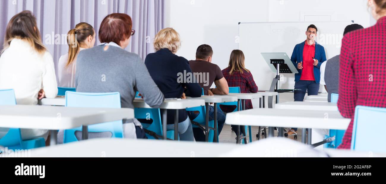 Students with teacher studying in classroom Stock Photo