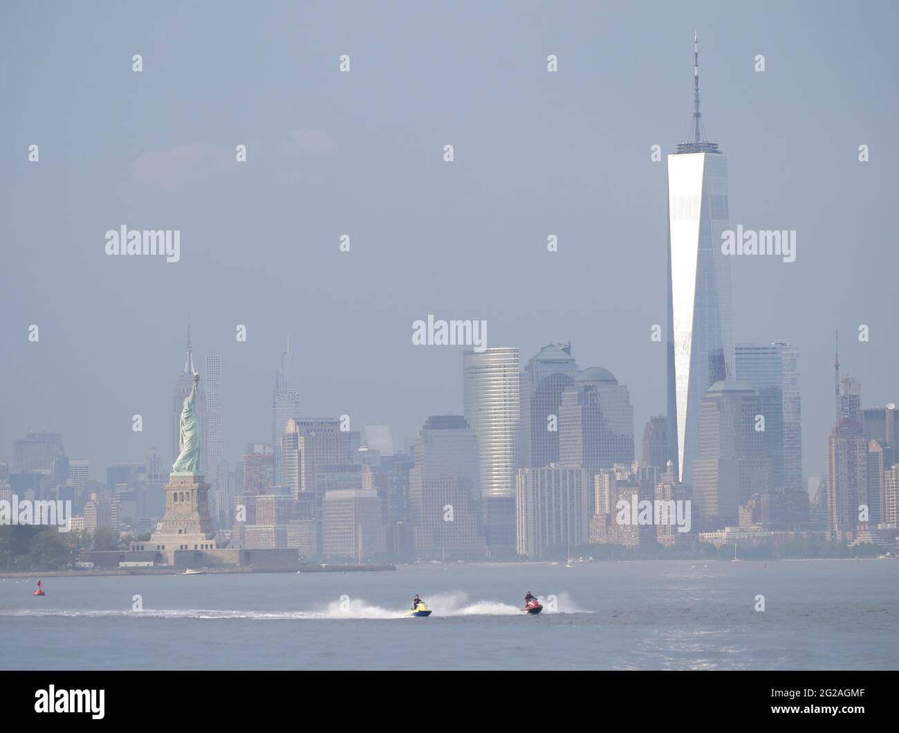 Bayonne, United States. 09th June, 2021. People ride jet skis in the Hudson River with a view of