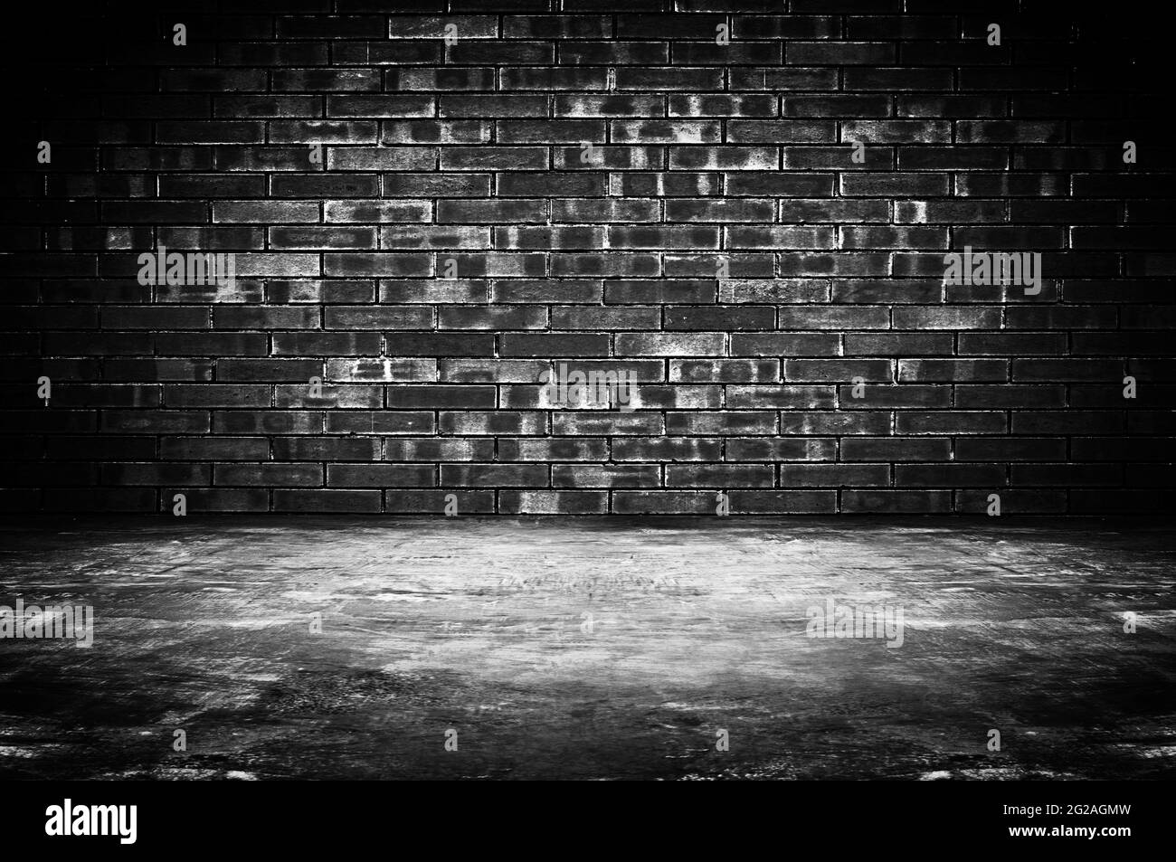 Old dark room with brick wall and concrete floor - as background Stock Photo