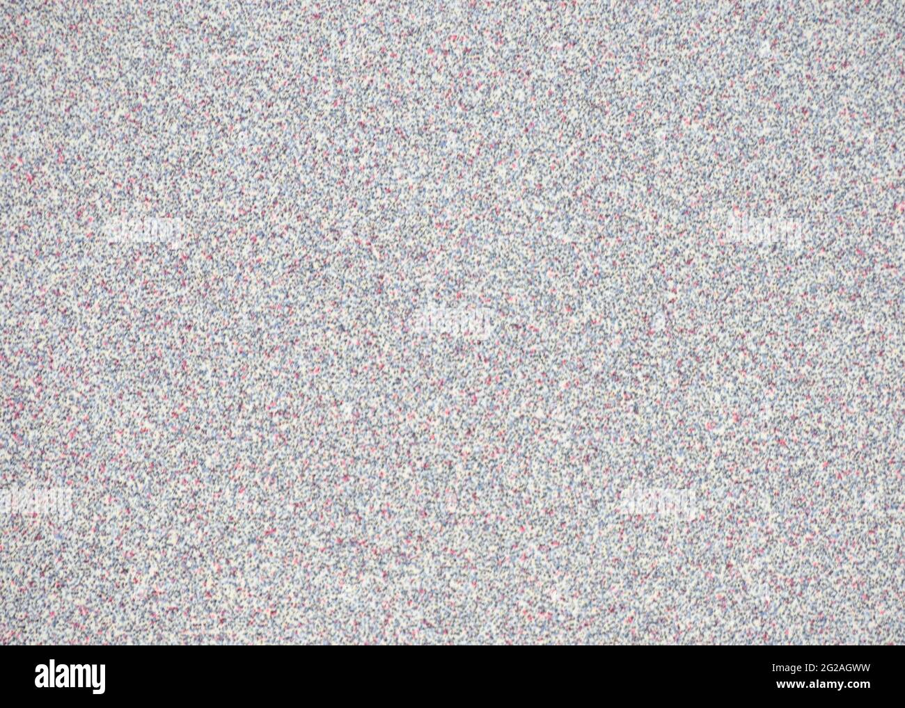Gray granite with small red, white and black blotches. Background, pattern, texture. Stock Photo