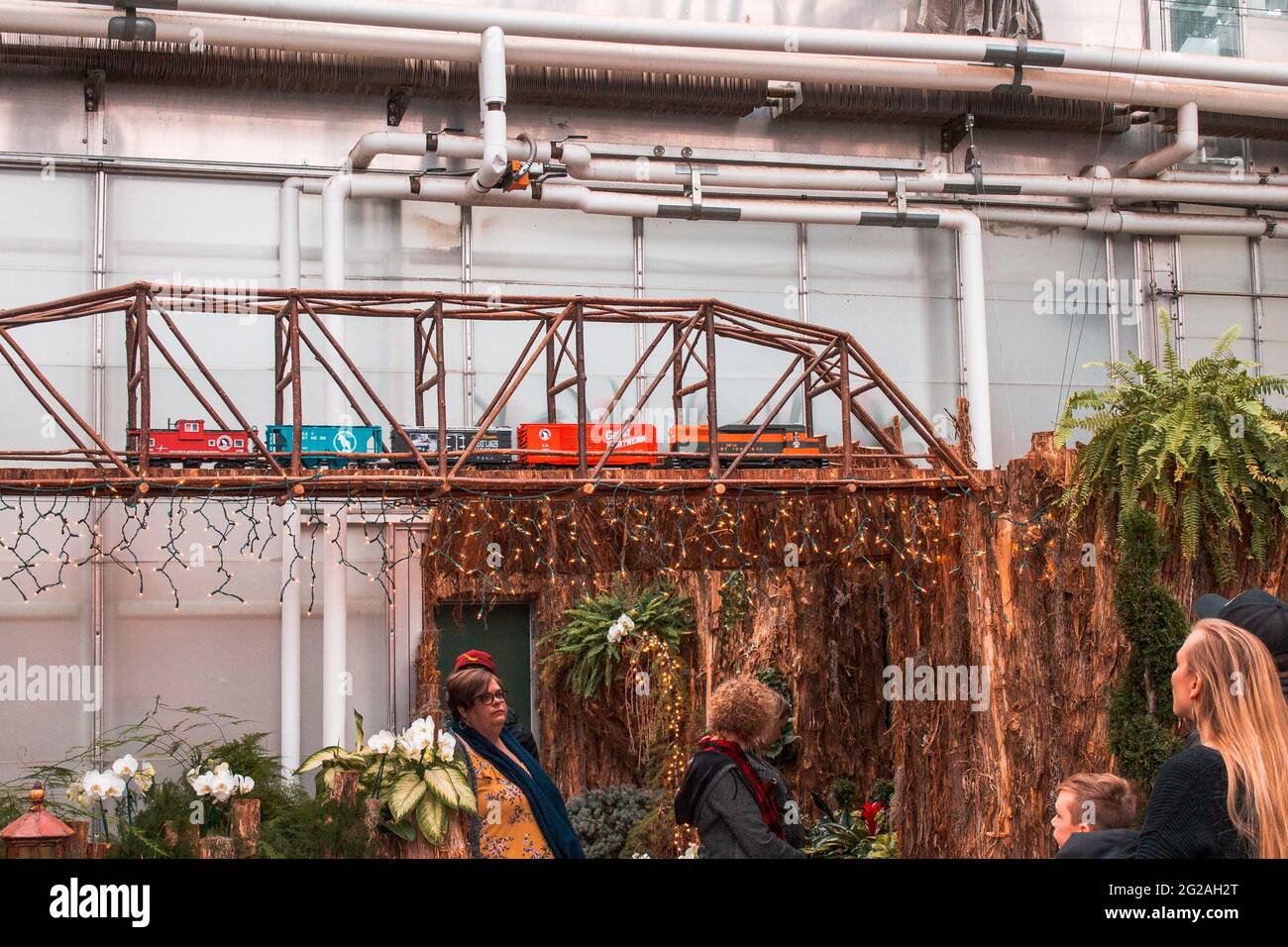 Model train crossing a bridge in the seasonal garden Stock Photo Alamy