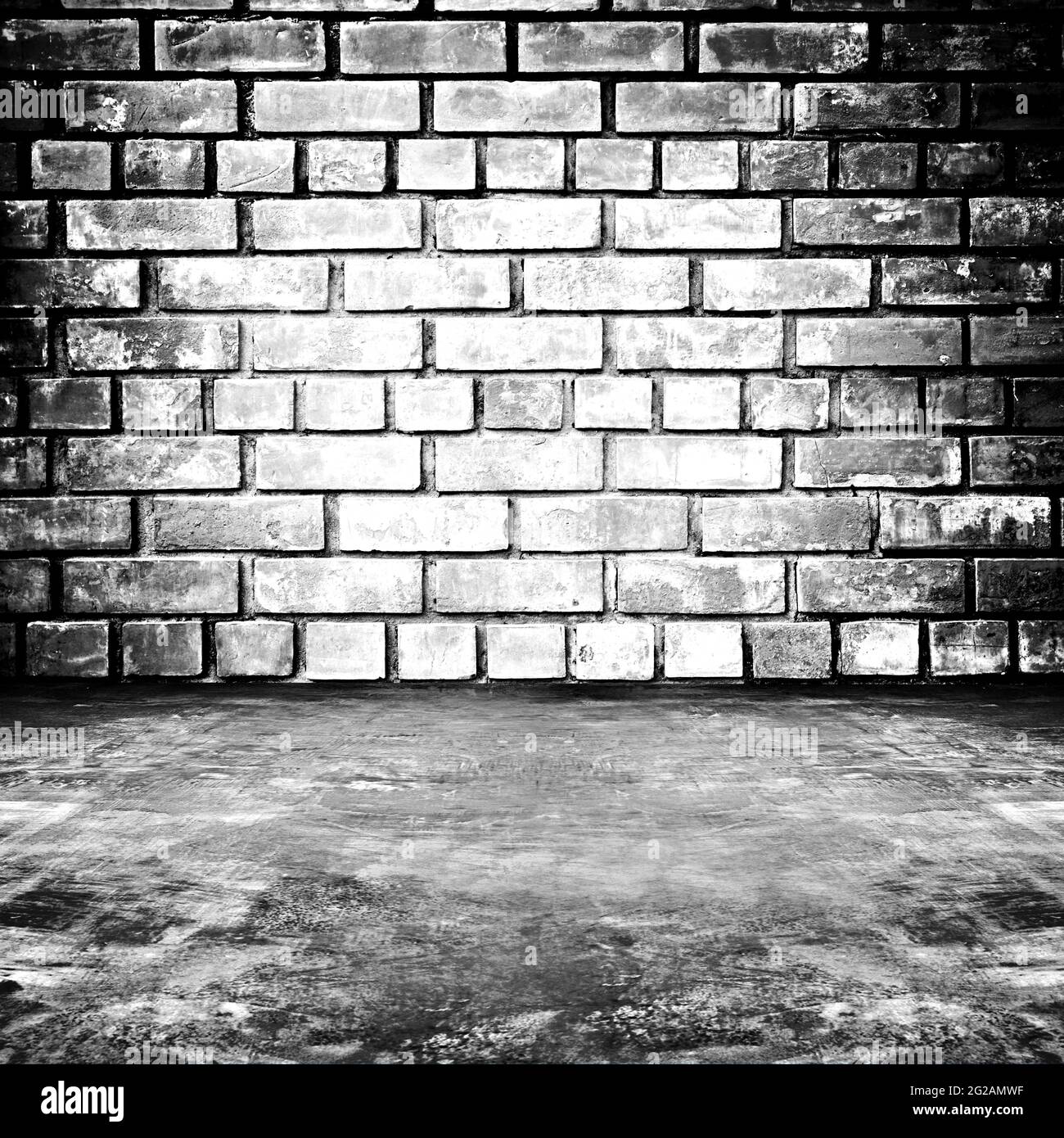 Old dark room with brick wall and concrete floor - as background Stock Photo